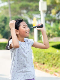 Happy girl holding badminton racket