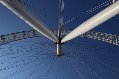 Low angle view of  ferris wheel / london eye against clear blue sky