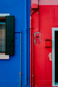 Detail on houses colored blue and red in burano