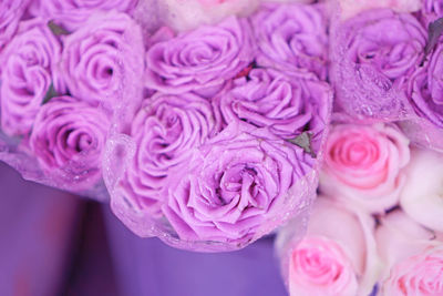 A bouque of red roses with droplet in plastic wrap