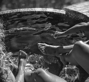 Close-up of hands against water