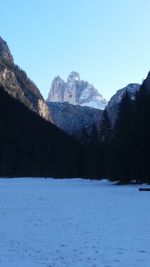 Scenic view of snowcapped mountains against clear blue sky