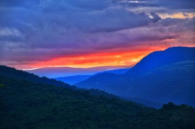 Scenic view of mountains against dramatic sky