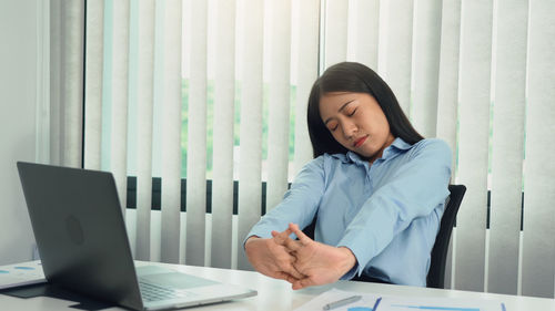 Young woman using laptop at office