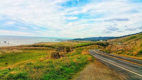 Empty road along countryside landscape