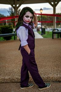 Full length portrait of girl standing outdoors