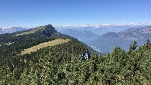 Scenic view of mountains against blue sky