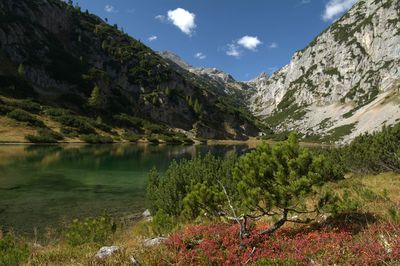 Scenic shot of calm countryside lake against mountain range