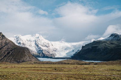 Scenic view of snowcapped mountains against sky