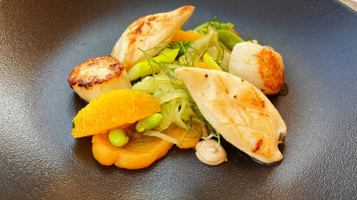 High angle view of fruits in plate on table