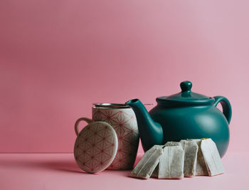 Close-up of pink paint on table against wall