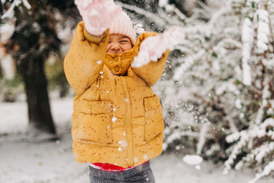 Toddler girl happy with snow day in winter. playing outside on christmas holiday. high quality photo