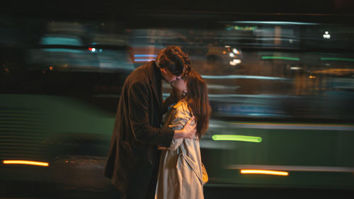 Young woman standing in city at night