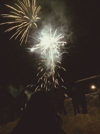 Low angle view of firework display at night