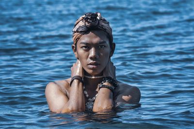 Portrait of young man swimming in lake