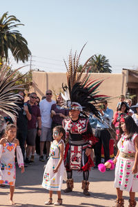 People in traditional clothing against sky