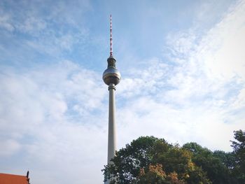 Low angle view of fernsehturm against cloud sky