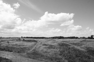 Scenic view of landscape against cloudy sky