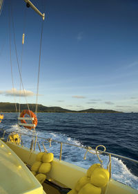 Sailboats in sea against sky