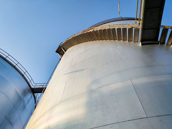 Low angle view of factory against clear blue sky