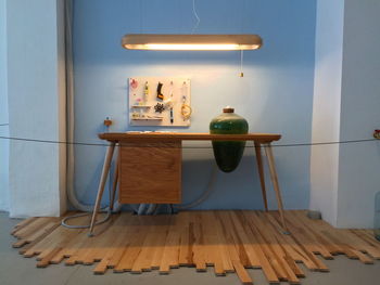 Wooden table under fluorescent light at home