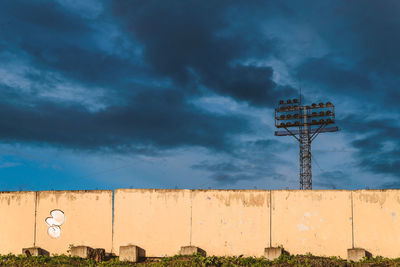 Wind turbine against cloudy sky