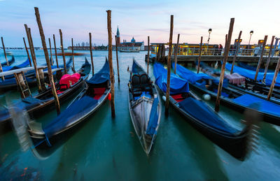 Gondolas moored in water