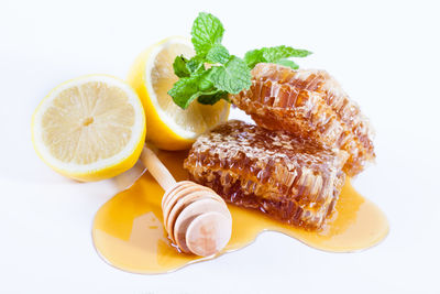 High angle view of fruits in plate against white background