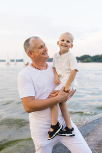 Portrait of young man sitting at beach