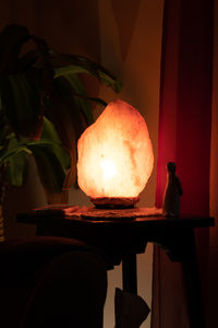 Close-up of illuminated lamp on table at home
