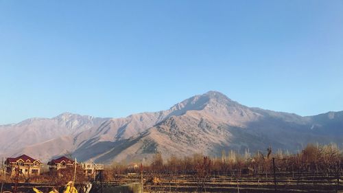 Scenic view of mountains against clear blue sky