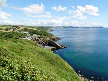 Scenic view of sea and coast against sky