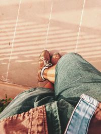 Low section of man standing on footpath