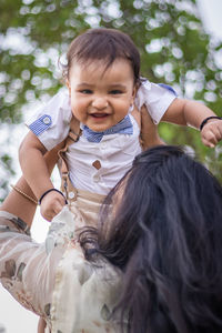 Isolated cute toddler with innocent facial expression at outdoor from different angle at day