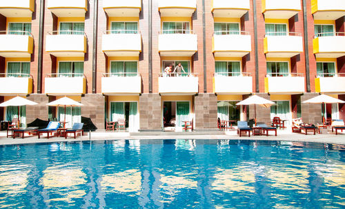 Reflection of buildings in swimming pool