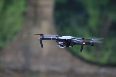 Close-up of drone flying against blurred background