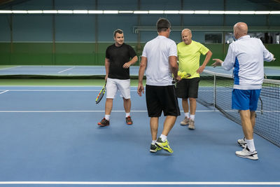 Men at tennis court