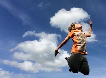 Low angle view of woman jumping