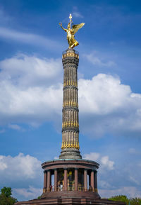 Low angle view of statue against cloudy sky