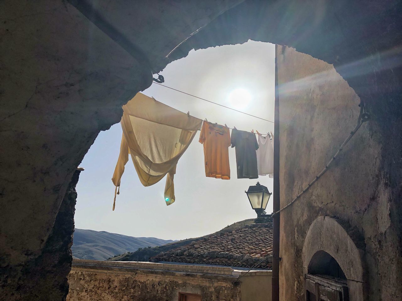 LOW ANGLE VIEW OF CLOTHES DRYING ON BUILDING