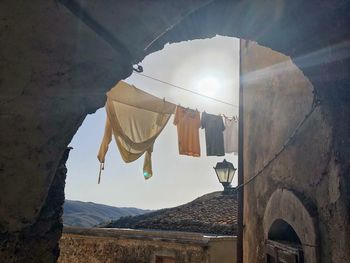 Low angle view of clothes drying against building