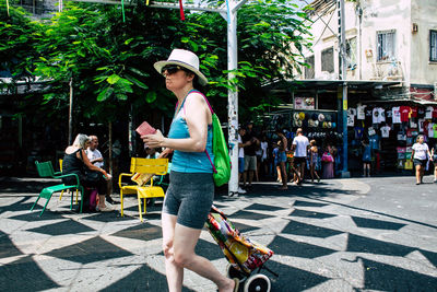 Full length of friends on street in city