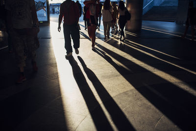 Low section of people walking on street