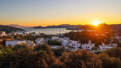 Scenic view of townscape against sky during sunset