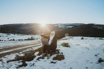 Happy woman freelancer with laptop outdoors enjoying financial freedom working remotely