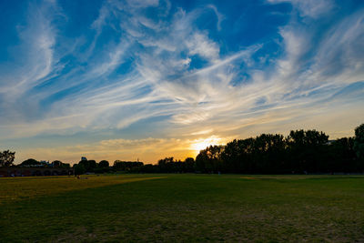 Scenic view of field against sky during sunset