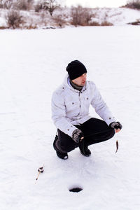 Man with umbrella on snowy land