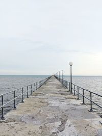 Pier over sea against sky