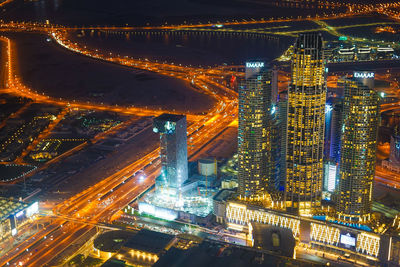 Aerial view of illuminated modern buildings in city at night