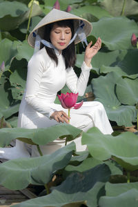 Full length of woman holding plant